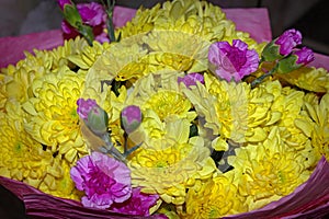 Yellow chrysanthemum mixed with pink carnation bouquet with selective focus on yellow and pink flower