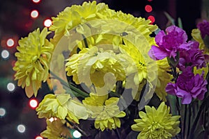 Yellow chrysanthemum mixed with pink carnation bouquet with selective focus on yellow and pink flower