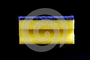 Yellow cleaning sponge black background