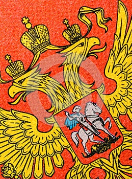 Yellow coat of arms on a red background