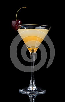 Yellow cocktail decorated with cherry in martini cocktails glass