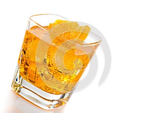 Yellow cocktail tilted with orange slice isolated on white background