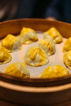 Yellow color Cheese Xiao Long Bao Chinese Soup Dumpling in bamboo steamer