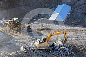 Yellow color excavator and bulldozer are evcavation in the construction site.