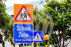 Yellow color warning school zone traffic sign on road