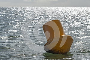 Yellow colored buoy in the sea