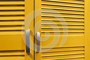 Yellow colored cupboard doors with handles
