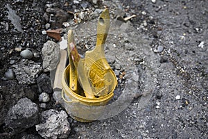 Yellow colored Paint brushes in a jar