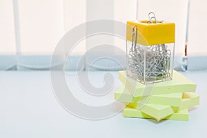 Yellow colored paper stickers with paper clip isolated on a white background