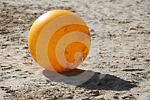 Yellow colored physioball on the sand