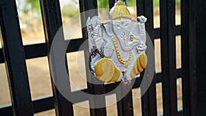Yellow colored view of Lord ganesha statue good luckon main entrance it`s use in festival season