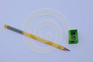 The  yellow  colour wooden peels pencils with green sharpner  isolated in white background.