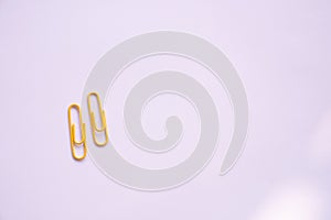 Yellow Coloured paper clips on a white background
