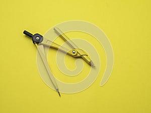 Yellow compass over a yellow background