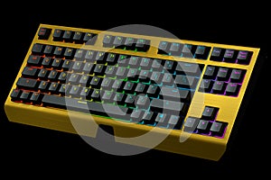 Yellow computer keyboard with rgb colors isolated on black background.