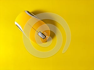 yellow computer mouse on yellow background