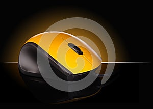 Yellow computer mouse on a black background