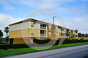 Yellow condos or apartments and a small pond