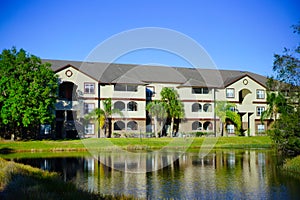 Yellow condos or apartments and a small pond