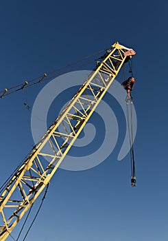 Yellow construction crane and blue sky.