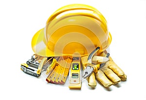 Yellow construction tools under helmet isolated