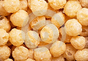 Yellow corn flour balls close-up texture.