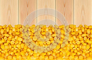 Yellow corn grain on wooden table background