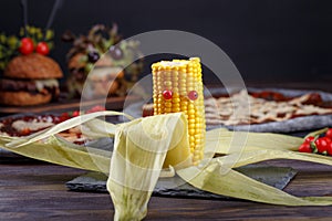 Yellow corn monster with red eyes. Funny healthy snack. Halloween party