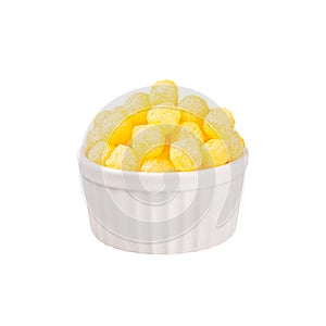 Yellow corn sticks balls in white ceramics bowl isolated on white background.