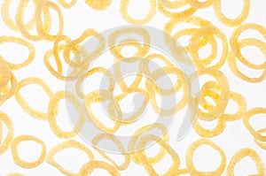 Yellow corn sticks rings on white background, pattern, top view.