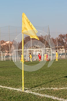 Yellow Corner Flag in Soccer Field during Children League Match