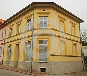 Yellow corner house listed as monument in Guetzkow, Mecklenburg-Vorpommern, Germany