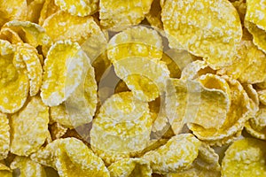 Yellow Cornflakes close up photo, Food texture background, top view. Macro shot. Perfect breakfast