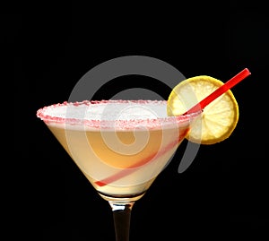 Yellow cosmopolitan cocktail decorated with citrus lemon and red straw