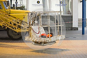 yellow crane lifting mechanism with lift platform near cash registers in railway station. photo