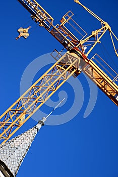 Yellow crane (steeve) and dome with spire of the cathedral photo