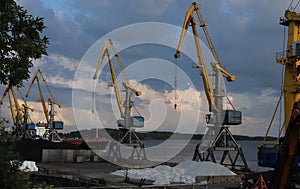 yellow cranes in the cargo river port. coal for loading into the freight train. Port in Vyborg on the Gulf of Finland