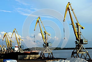 yellow cranes in the cargo river port. coal for loading into the freight train. Port in Vyborg on the Gulf of Finland