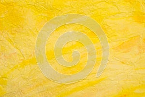 Yellow creased colored tissue paper background texture