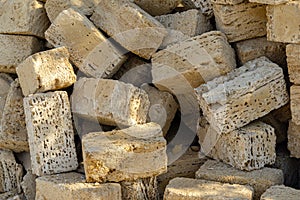 Yellow crimean sawn limestone prepared for construction of building. Traditional porous heat-insulating stone for walls
