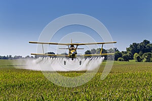 Yellow Crop Duster Spraying Pestisides On Crops