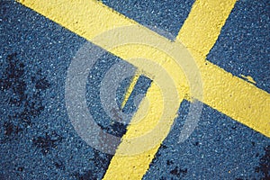 yellow cross on the pavement