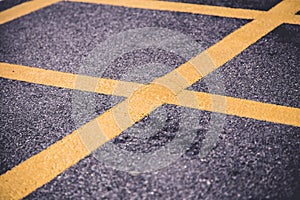 yellow cross on the pavement