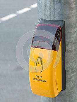 Yellow crosswalk button on the pedestrian crossing