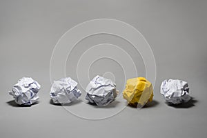 Yellow crumpled paper ball.Business creativity,leadership concept