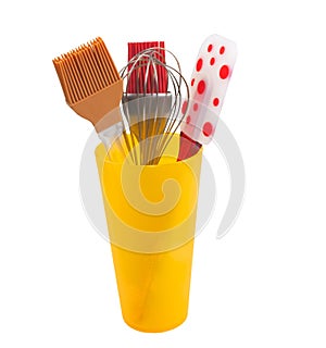 Yellow cup holding kitchen utensil