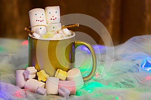 Yellow cup of hot beverage with melted funny marshmallow snowman