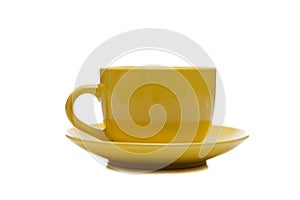 A yellow cup and saucer on white