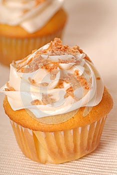 Yellow cupcake with lemon buttercream frosting photo