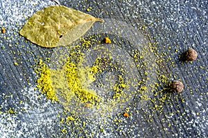 Yellow curry powder on dark wooden background